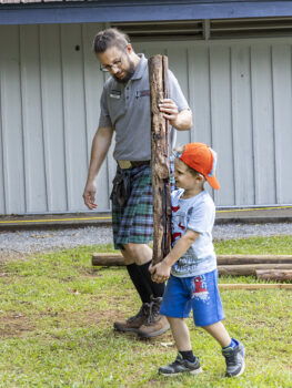 child tossing a caber